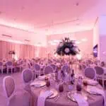 Prostrana dvorana za evente s modernim uređenjem, cvjetnim dekoracijama i ugodnom atmosferom za sve.